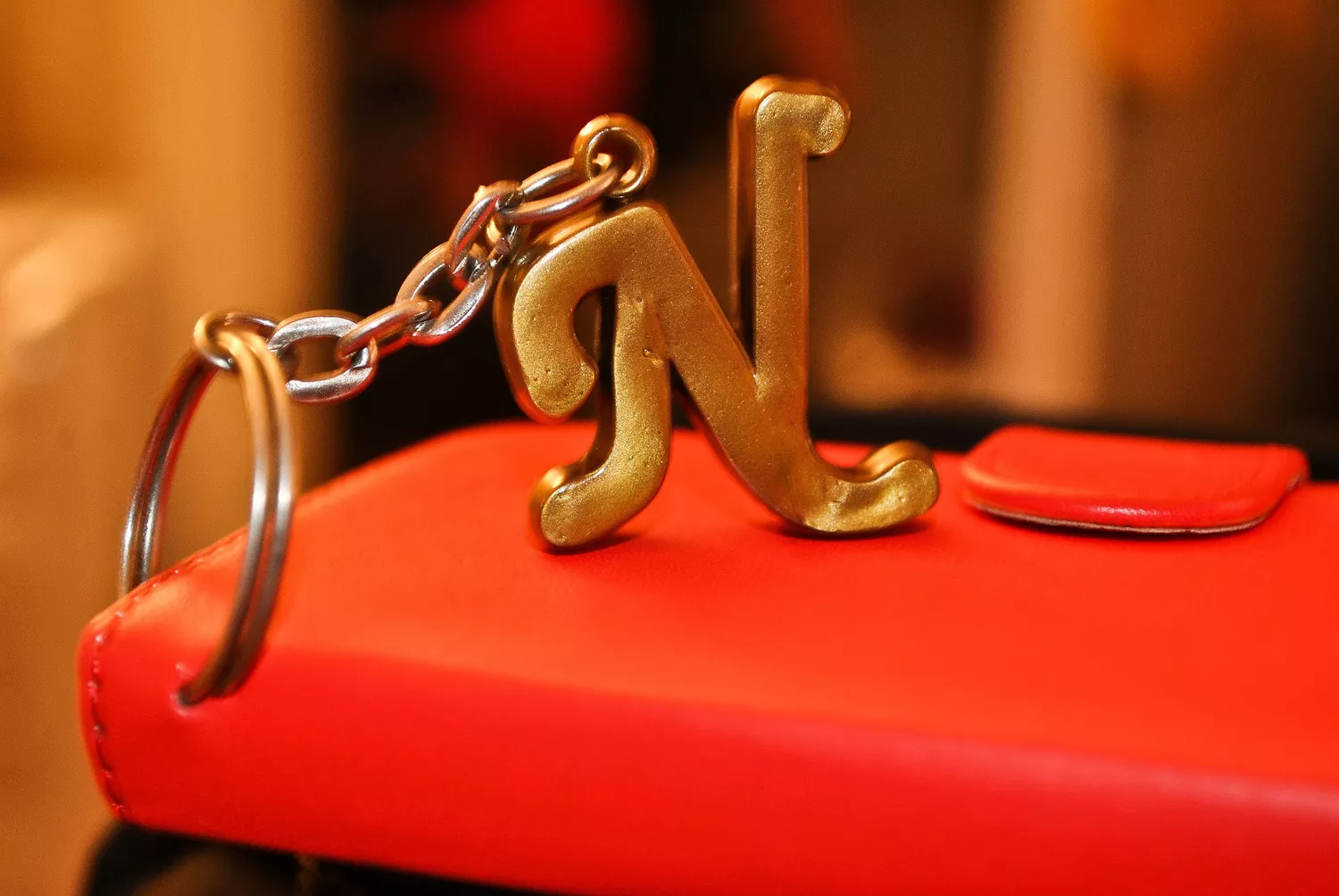 Capital "N" key ring attached to a red book close up.